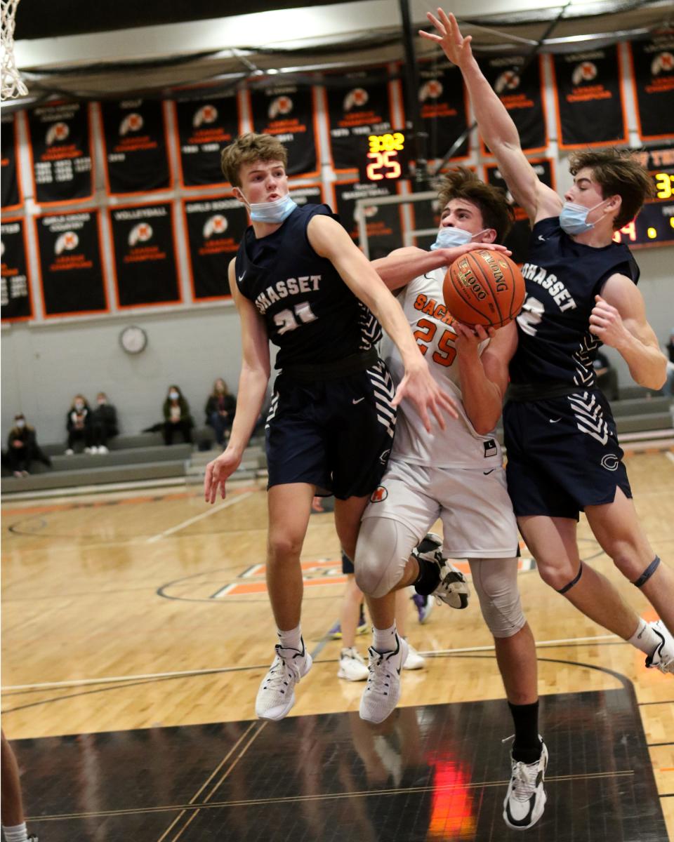 Cam Downey battles to get to the hoop Tuesday night against Cohasset. 