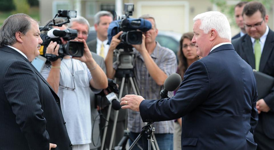 Scott Bremner, left, is shown in this 2012 file photo interviewing then Pennsylvania Gov. Tom Corbett at Zuck Park in Millcreek Township. Bremner died Monday, May 8. He was 63.