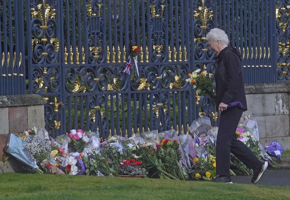 Lady Mary Elizabeth Peters lays flowers at the gates of Hillsborough Castle in County Down, as she pays her respects following the death of Queen Elizabeth II on Thursday.Picture date: Friday September 9, 2022. See PA story DEATH Queen UlsterHillsborough. Photo credit should read: Mark Marlow/PA Wire