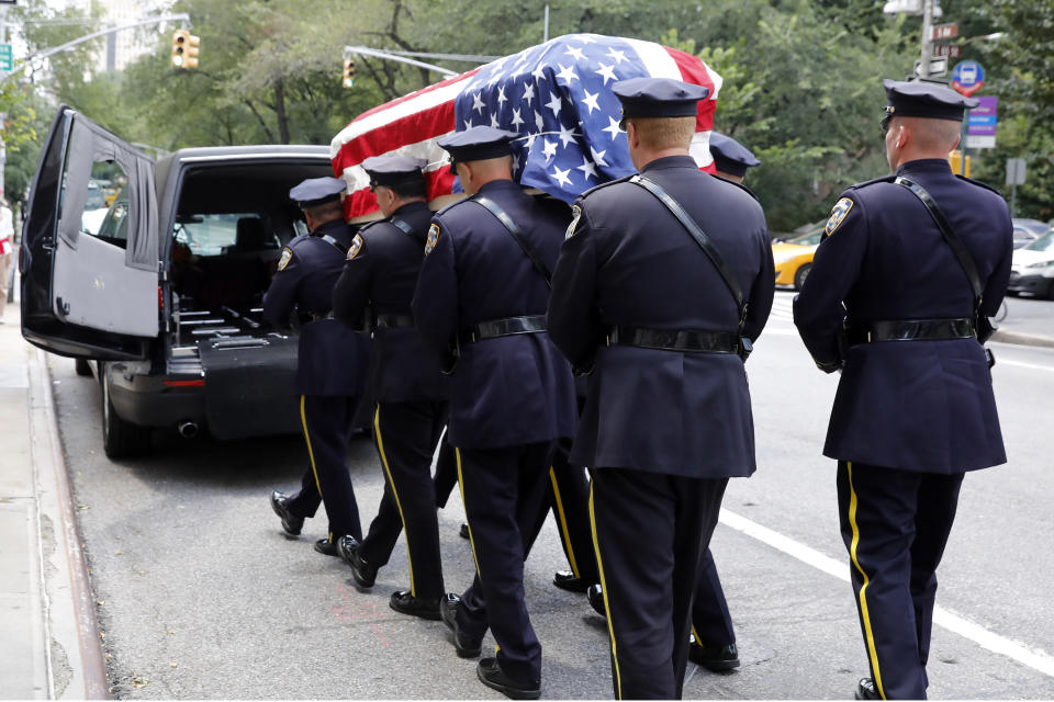 New York City Police Dept. officers carry the casket of former Manhattan District Attorney Robert Morgenthau following a funeral service at Temple Emanu-El, in New York, Thursday, July 25, 2019. (AP Photo/Richard Drew)