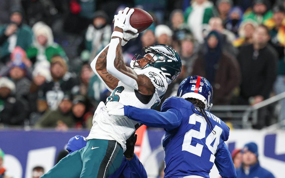 Jan 7, 2024; East Rutherford, New Jersey, USA; Philadelphia Eagles wide receiver Quez Watkins (16) catches a touchdown pass in front of New York Giants safety Dane Belton (24) during the second half at MetLife Stadium. Mandatory Credit: Vincent Carchietta-USA TODAY Sports