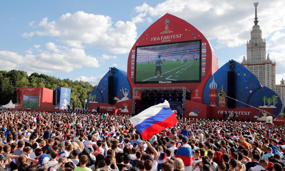 Fans watch the match between Uruguay and Russia on a big screen in Moscow.