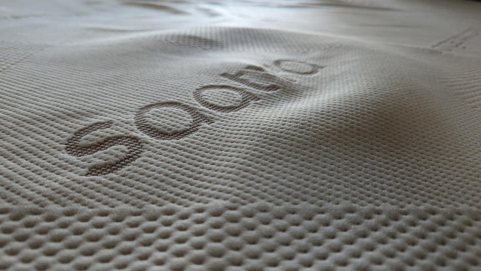 A close-up shot of the Saatva Graphite Memory Foam Mattress Topper's cover