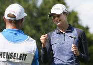 Esther Henseleit, right, of Germany, fist bumps her caddie Chris Murphy, left, after making a birdie on the 12th hole during the final round of the LPGA Volunteers of America Classic golf tournament in The Colony, Texas, Sunday, July 4, 2021. (AP Photo/Ray Carlin)