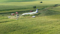 In this video grab provided by the RU-RTR Russian television, a Russian Ural Airlines' A321 plane is seen after an emergency landing in a cornfield near Ramenskoye, outside Moscow, Russia, Thursday, Aug. 15, 2019. The Russian pilot was being hailed as a hero Thursday for safely landing his passenger jet in a corn field after it collided with a flock of gulls seconds after takeoff, causing both engines to malfunction. (RU-RTR Russian Television via AP)