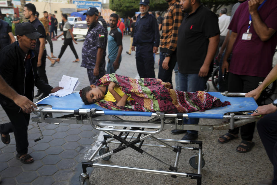 A Palestinian child wounded in Israeli bombardment is brought to a hospital in Deir el-Balah, Gaza Strip, Monday, Oct. 16, 2023. (AP Photo/Adel Hana)