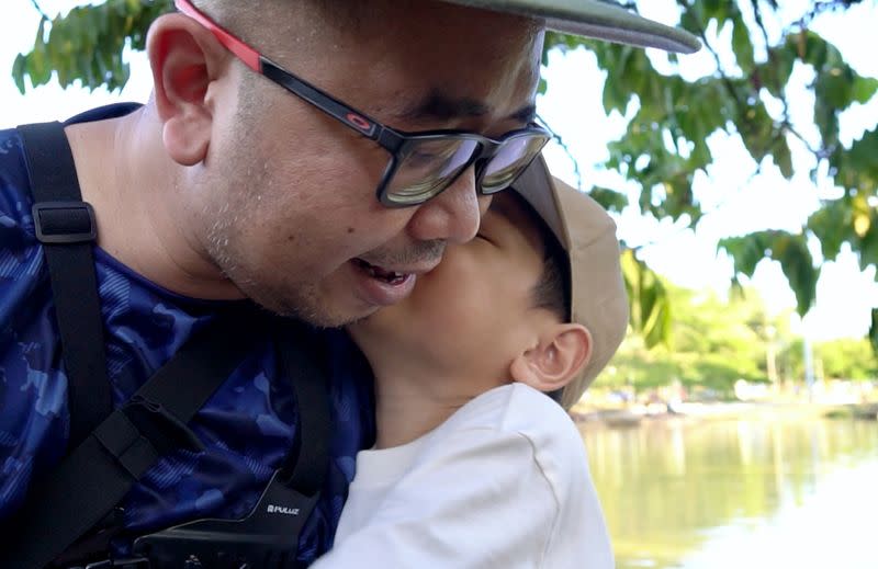 Singaporean Mohammad Faris Abdullah, 37, reunites with his 6-year-old son Muhammad Ishaq bin Mohammad Faris after being separated for two years amid the COVID-19 pandemic, in Johor