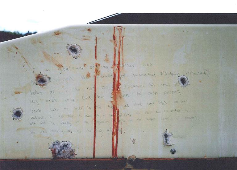 Undated evidence photo shown to jurors on March 10, 2015 in Boston, courtesy of the US Department of Justice, shows a handwritten bloodstained note found inside the boat with bullet holes where Dzhokhar Tsarnaev was found hiding in Watertown