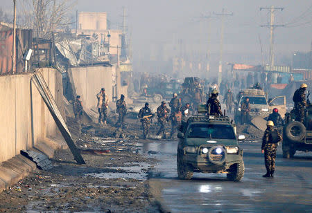 FILE PHOTO: Afghan security forces inspect the site of a car bomb blast at green village in Kabul, Afghanistan January 15, 2019. REUTERS/Mohammad Ismail/File Photo