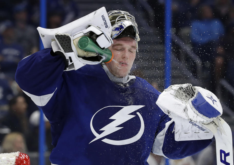 Tampa Bay Lightning goaltender Andrei Vasilevskiy (88) sprays water on his face during the third period of an NHL hockey game against the Toronto Maple Leafs Thursday, Dec. 13, 2018, in Tampa, Fla. (AP Photo/Chris O'Meara)