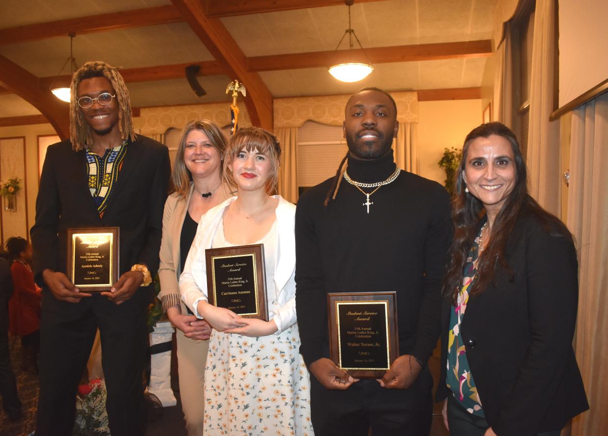 Three Lenawee County students were recognized with Student Service Awards Monday, Jan. 16, 2023, during Lenawee County's annual Martin Luther King Jr. Community Celebration and Dinner. They are Ayodele Adeniye, left, Adrian College junior; Carrianne Ausmus, center, Jackson College/Lenawee Intermediate School District Academy student; and Walter Turner Jr., second from right, Siena Heights University senior. Also pictured are Kim Dusseau, second from left, principal of the JC/LISD Academy, who sponsored Ausmus, and Heather Moore, right, director of the McNair Scholars Program at SHU, who sponsored Turner. Adeniye was sponsored by Adrian College Dean of Student Affairs Thomas Doney, who is not pictured.