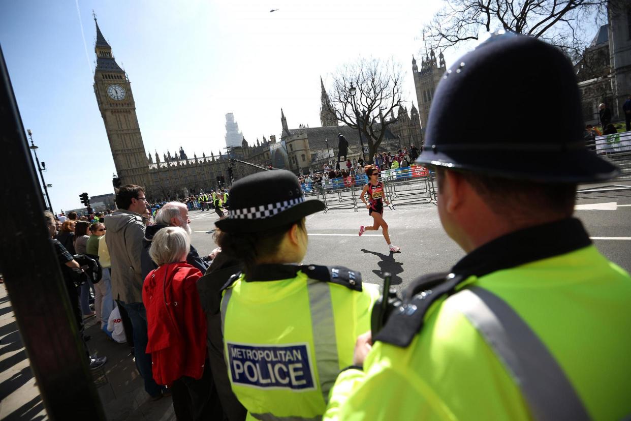 Security: Police watch in Parliament Square as a runner heads for the finish of the London Marathon: Getty Images