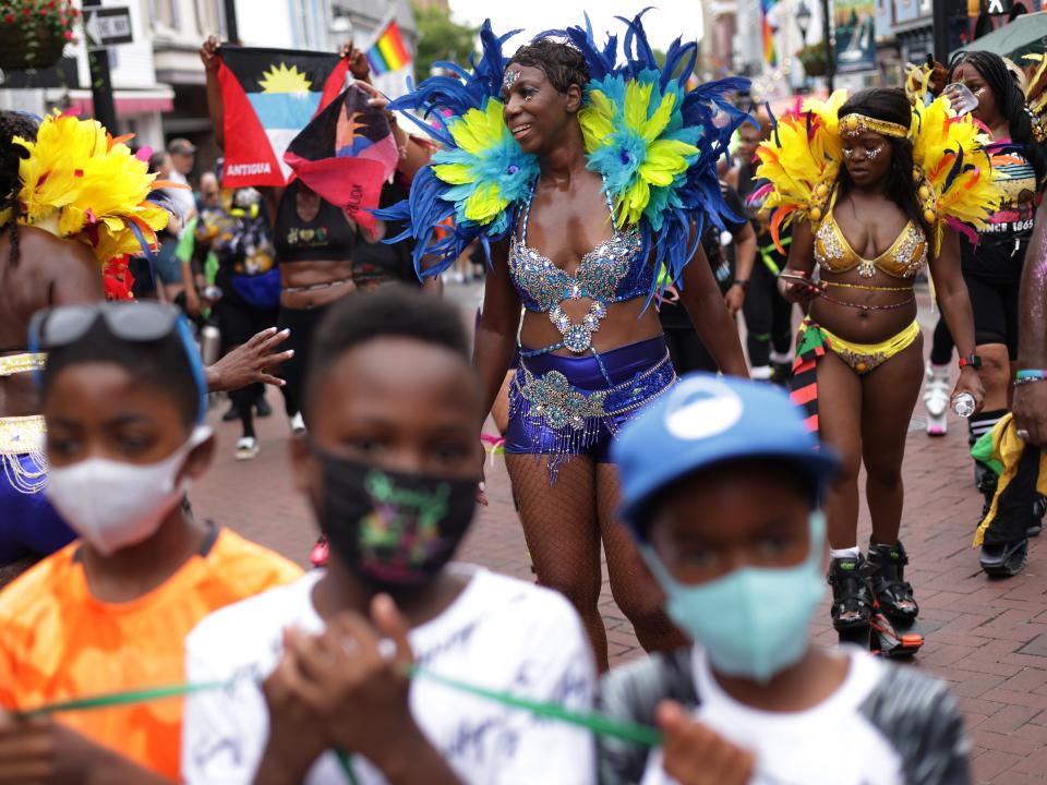 La'Verne Webb (C) of Soul2Sole Bounce Fitness wears a carnival costume as she participates in a parade to celebrate Juneteenth on June 19, 2021 in Annapolis, Maryland.