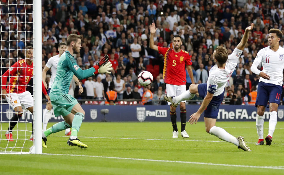 Spain goalkeeper David de Gea, center left, stops a shot from England's Harry Kane, center right, during the UEFA Nations League soccer match between England and Spain at Wembley stadium in London, Saturday Sept. 8, 2018. (AP Photo/Frank Augstein)