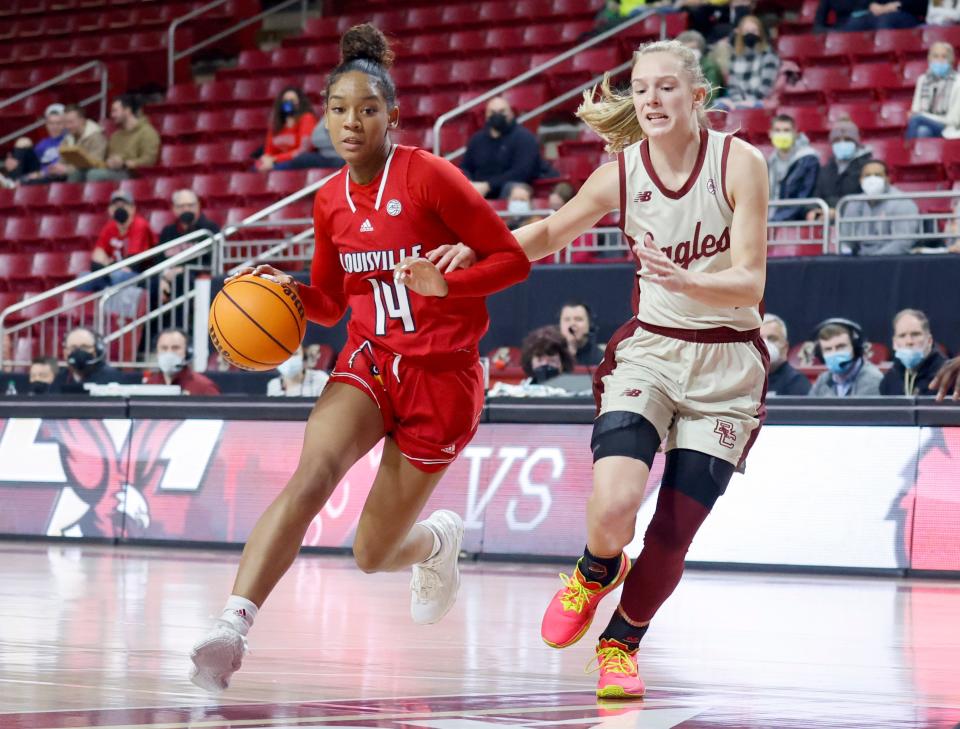 Louisville guard Kianna Smith (14) drives the ball up the court as Boston College guard Cameron Swartz (1) defends during the first half of an NCAA college basketball game, Sunday, Jan. 16, 2022, in Boston. (AP Photo/Mary Schwalm)