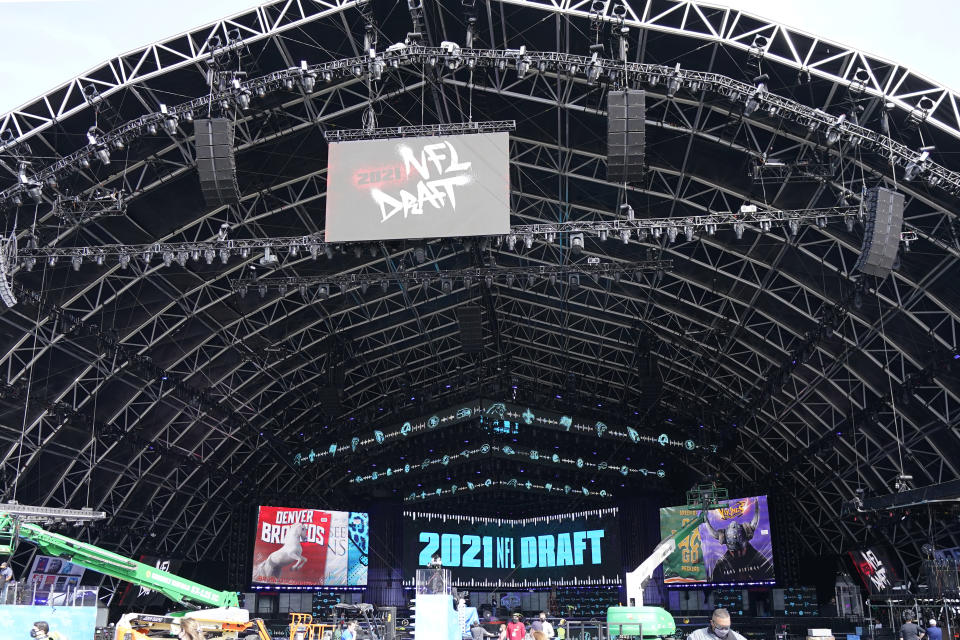 Workers continue preparing the NFL Draft Theatre for the 2021 NFL Draft, Tuesday, April 27, 2021, in Cleveland. After going all virtual in 2020 due to the COVID-19 pandemic, the three-day draft, which has grown into one of America's biggest, non-game sporting events, returns with thousands of fans who will be separated by their loyalties, and whether they've been vaccinated. (AP Photo/Tony Dejak)