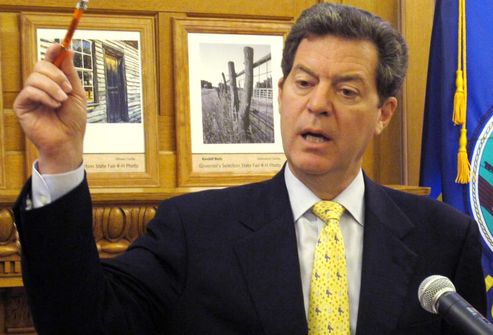 Kansas Gov. Sam Brownback makes a point in discussing the state's finances during a news conference, Wednesday, July 25, 2012, at the Statehouse in Topeka, Kan. Brownback argues that income tax cuts approved this year won't cause big budget problems in the future, as critics fear. (AP Photo/John Hanna)