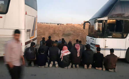 Rebels pray before they are evacuated from the town of Douma, eastern Ghouta, in Damascus, Syria April 1, 2018. REUTERS/Bassam Khabieh