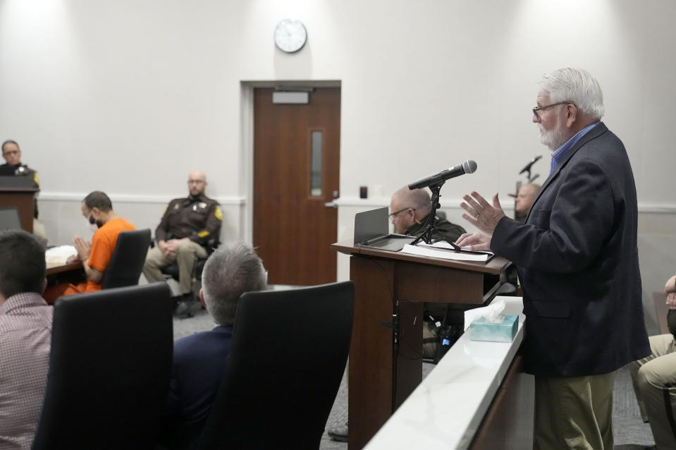 Bill Mitchell, who was injured marching with a group with the Catholic Community of Waukesha, reads a statement during Darrell Brooks' sentencing in a Waukesha County Circuit Court in Waukesha, Wis., on Tuesday, Nov. 15, 2022. Dozens of people are expected to speak at the sentencing proceedings for Brooks, who is convicted of killing six people and injuring dozens more when he drove his SUV through a Christmas parade in Waukesha last year. (Mike De Sisti/Milwaukee Journal-Sentinel via AP, Pool)