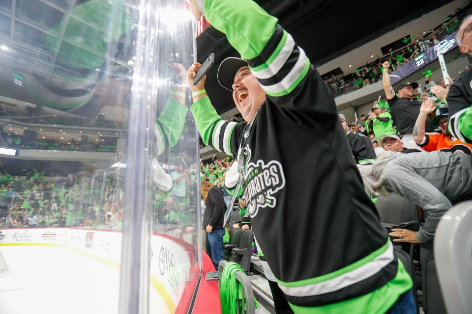A fans beats on the glass as they celebrate a goal during the Savannah Ghost Pirates home opener on Saturday November 5, 2022 against the Greenville Swamp Rabbits.
