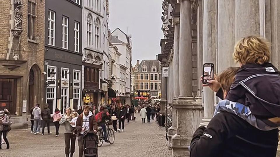 alex jones and family walking through Bruges 