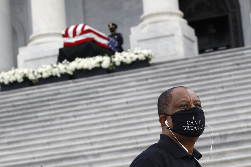 Richard Toye of Washington wears a face mask to protect against the spread of the new coronavirus as he departs after viewing the flag-draped casket of Rep. John Lewis, D-Ga., on the East Front Steps of the Capitol in Washington, Tuesday, July 28, 2020. (AP Photo/Patrick Semansky)