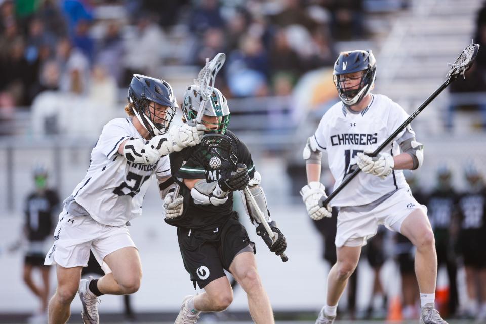 Olympus’ Ethan Hartsfield (6) defends the ball against Corner Canyon’s William Perry (12) and Easton Daynes (26) during a high school boys lacrosse game at Corner Canyon High School in Draper on April 14, 2023. | Ryan Sun, Deseret News