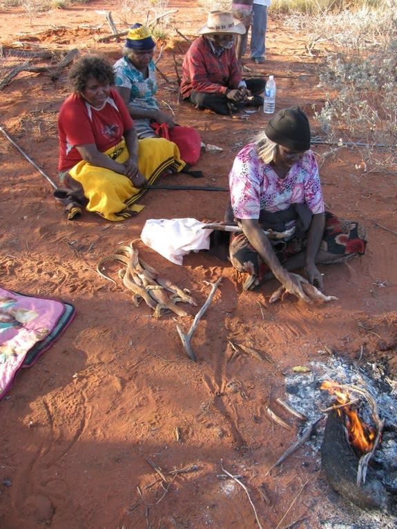 Nyalangka Taylor, Karnu Taylor and Ngameru Bidu hunt for sand monitor lizards near Parnngurr community in Australia in August 2012.