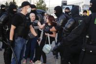 Police detain protesters during a mass protest following presidential elections in Minsk, Belarus, Monday, Aug. 10, 2020. Thousands of people have protested in Belarus for a second straight night after official results from weekend elections gave an overwhelming victory to authoritarian President Alexander Lukashenko, extending his 26-year rule. A heavy police contingent blocked central squares and avenues, moving quickly to disperse protesters and detained dozens. (AP Photo/Sergei Grits)