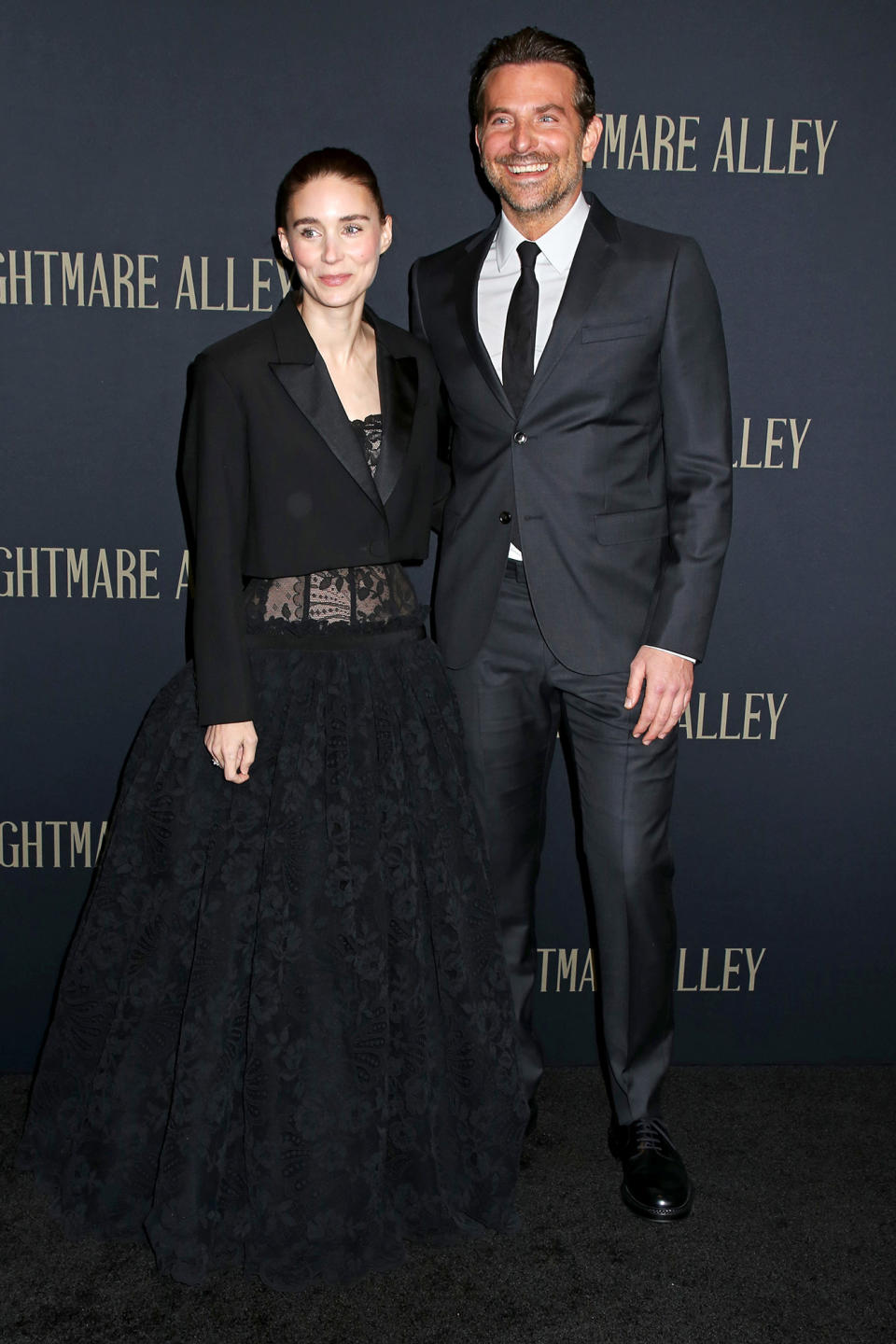 <p>Rooney Mara and Bradley Cooper share smiles on Dec. 1 at the <em>Nightmare Alley </em>premiere in N.Y.C.</p>