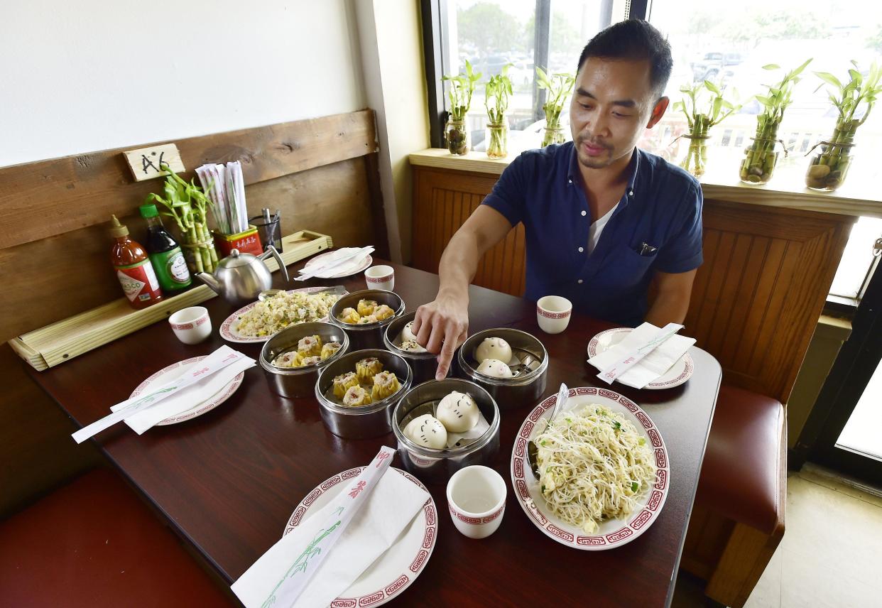 Guorung Fan, the owner Lucky Cat Dim Sum, sets up a table of selections from the menu prepared for visitors on Aug. 3. Lucky Cat Dim Sum is preparing for its Aug. 8 soft opening at 10550 Old St. Augustine Road, Unit 28.