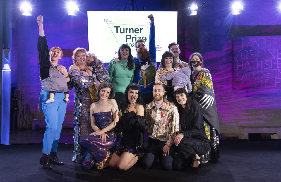 Array Collective are announced as the winner of the Turner Prize 2021, the leading international award for contemporary art, at Coventry Cathedral, Coventry, England, Wednesday Dec. 1, 2021. An 11-person collective from Belfast that aims to transcend Northern Ireland’s political and religious divides has won the U.K.’s prestigious Turner Prize for art. The Array Collective took the 25,000 pound ($33,000) prize on Wednesday for “The Druithaib’s Ball,” a recreation of a traditional Irish shebeen, or speakeasy full of references to 100 years of Northern Ireland history. (Matt Alexander/PA via AP)