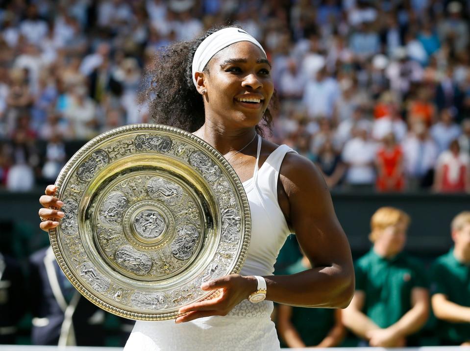 FILE - Serena Williams holds up the trophy after winning the women's singles final against Garbine Muguruza of Spain, at the All England Lawn Tennis Championships in Wimbledon, London, Saturday, July 11, 2015. Williams won 6-4, 6-4. Serena Williams says she is ready to step away from tennis after winning 23 Grand Slam titles, turning her focus to having another child and her business interests. "I'm turning 41 this month, and something's got to give," Williams wrote in an essay released Tuesday, Aug. 9, 2022, by Vogue magazine. (AP Photo/Kirsty Wigglesworth, File)