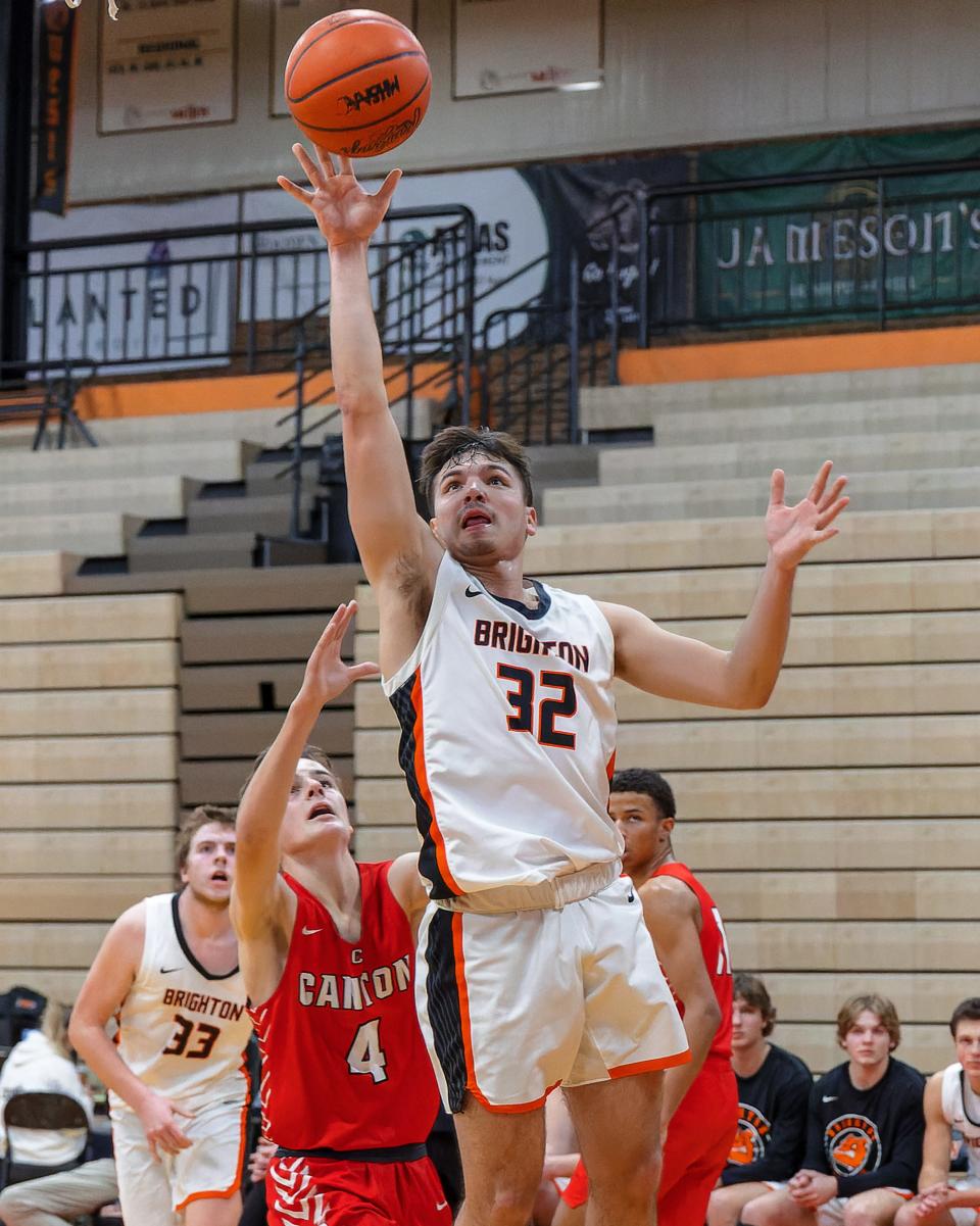 Brighton's Ashton Tomassi (32), who had a game-high 20 points, drives past Canton's Teddy Winstel (4) during the Bulldogs' 69-52 victory Tuesday, Jan. 24, 2023.