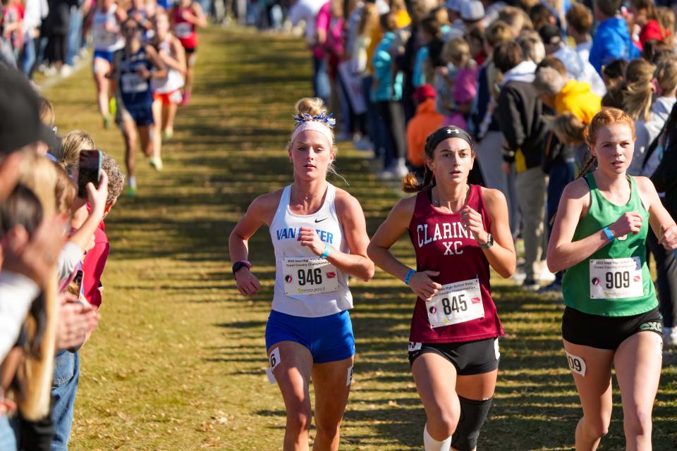 Clare Kelly of Van Meter, left, places 3rd in the Class 2A girls State Cross Country Championship in Fort Dodge, Friday, Oct. 28, 2022.