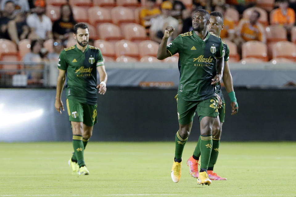 Portland Timbers' Diego Valeri, left, Dairon Asprilla, middle, and Jeremy Ebobisse, right, celebrate the goal by Asprilla during the second half of an MLS soccer match against the Houston Dynamo Wednesday, June 23, 2021, in Houston. (AP Photo/Michael Wyke)