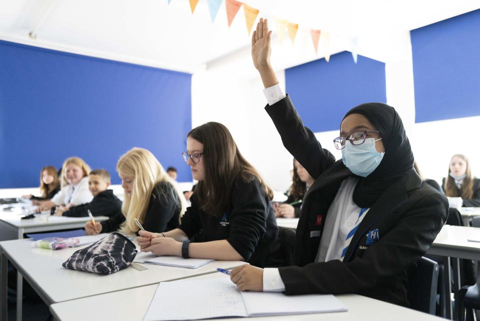 CARDIFF, WALES - SEPTEMBER 20: A child raises their hand during a maths lesson at Llanishen High School on September 20, 2021 in Cardiff, Wales. All children aged 12 to 15 across the UK will be offered a dose of the Pfizer-BioNTech Covid-19 vaccine. Parental consent will be sought for the schools-based vaccination programme. (Photo by Matthew Horwood/Getty Images)