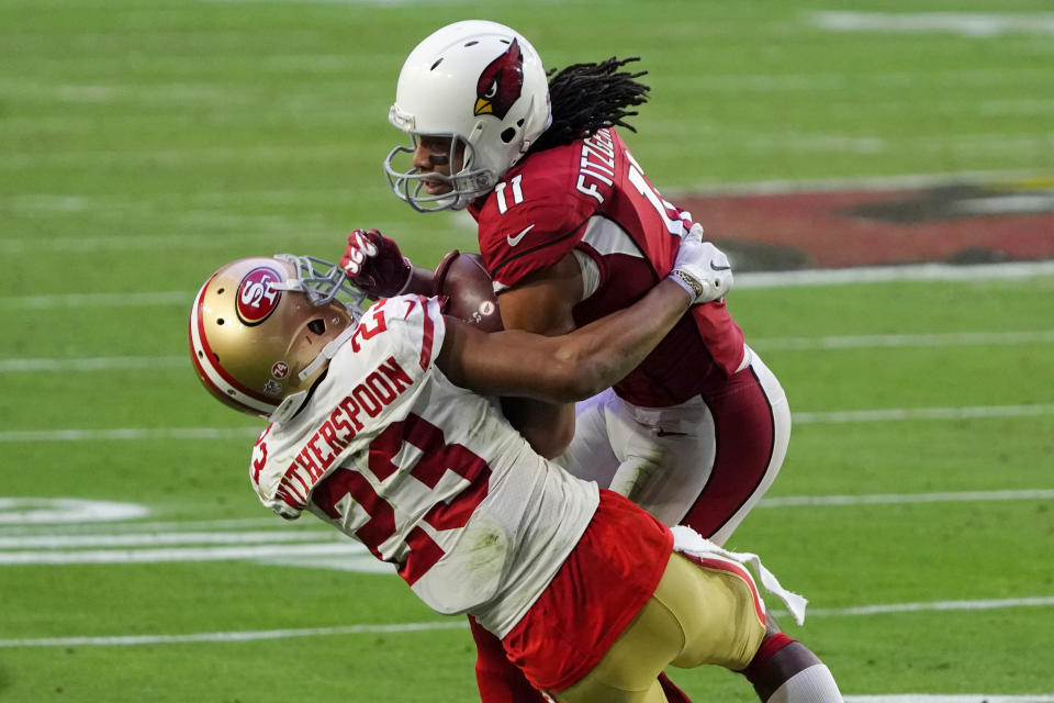 Arizona Cardinals wide receiver Larry Fitzgerald (11) makes a catch as San Francisco 49ers cornerback Ahkello Witherspoon (23) defends during the second half of an NFL football game, Saturday, Dec. 26, 2020, in Glendale, Ariz. (AP Photo/Rick Scuteri)