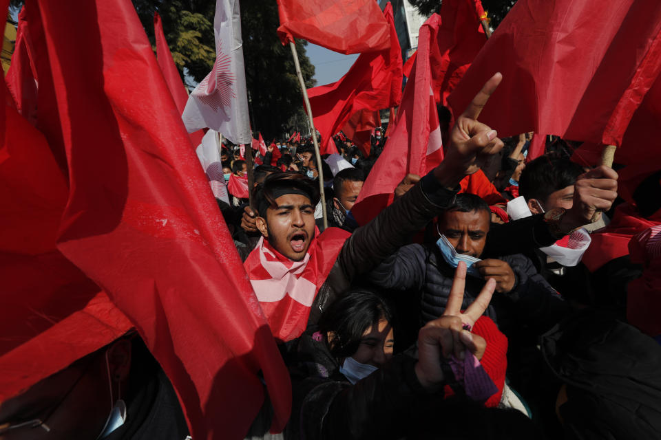 Nepalese supporters of the splinter group in the governing Nepal Communist Party participate in a protest in Kathmandu, Nepal, Tuesday, Dec. 29, 2020. Tens of thousands of supporters of the splinter group rallied in the capital on Tuesday demanding the ouster of the prime minister and the reinstatement of the Parliament he dissolved amid an escalating feud in the party. (AP Photo/Niranjan Shrestha)