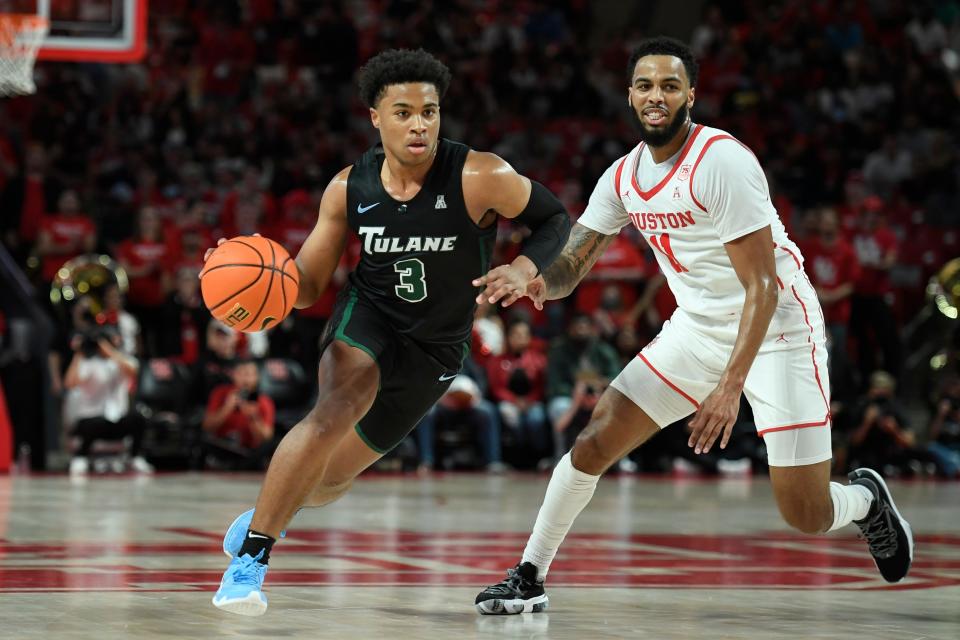 Tulane guard Jalen Cook (3) drives to the basket against Houston guard Kyler Edwards (11) last season.