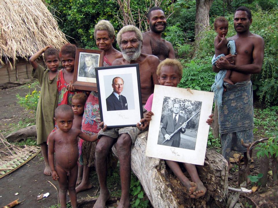 Villagers on the island of Tanna hold up treasured photos of Prince Philip (Richard Shears/Shutterstock)