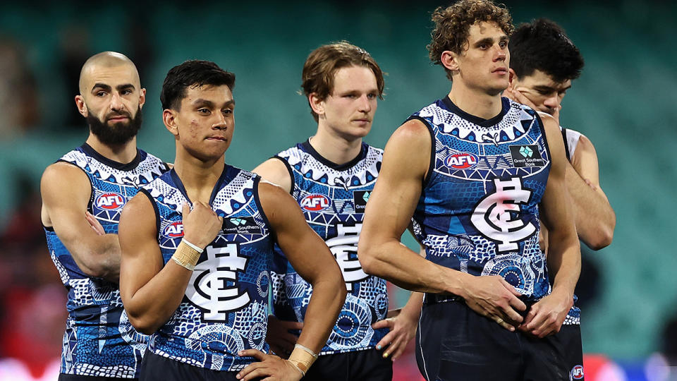 Carlton players look dejected as they walk off the ground following their loss to Sydney.