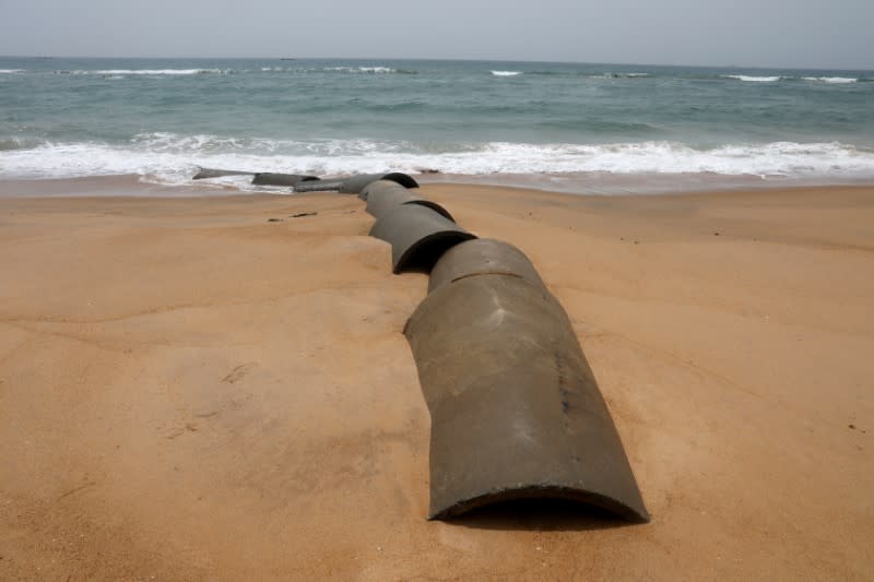 Canalization pipes that used to be part of a sewerage system are seen on the sandy beaches that are being destroyed by storms and coastal erosion, Lome