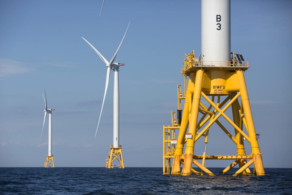 FILE - In this Monday, Aug. 15, 2016, file photo three wind turbines from the Deepwater Wind project stand in the Atlantic Ocean off Block Island, R.I. Fishermen are turning a wary eye toward an emerging upstart: the offshore wind industry. New Bedford, Mass., fishermen say they're concerned about navigating a forest of turbines to get to their historical fishing grounds and getting trawling gear caught up on transmission cables on the seafloor. (AP Photo/Michael Dwyer, File)