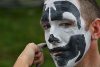 <p>A fan of the rap group Insane Clown Posse, known as Juggalos, gets his face painted as several thousand fans prepare to assemble on Sept. 16, 2017 near the Lincoln Memorial in Washington to protest at a 2011 FBI decision to classify their movement as a gang. (Photo: Paul J. Richards/AFP/Getty Images) </p>