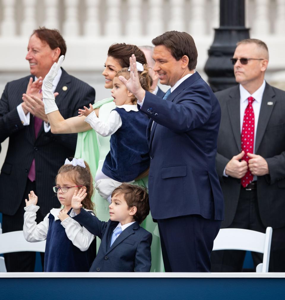 Gov. Ron DeSantis and his family wave to the crowd of people who attended his inauguration ceremony on the steps of the historic Capitol on Tuesday, Jan. 3, 2023. 
