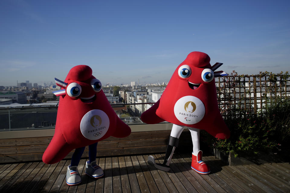 Mascots of the 2024 Paris Olympic Games, left, and Paralympics Games, a Phrygian cap, pose during a preview in Saint Denis, outside Paris, Thursday, Nov. 10, 2022. The soft bright red cap, also known as a liberty cap, is an updated version of a conical hat worn in antiquity in places such as Persia, the Balkans, Thrace, Dacia and Phrygia, where the name originates, in modern day Turkey. It later became a symbol of the pursuit of liberty in the French Revolution and is still worn by the figure of Marianne, the national personification of France since that time. (AP Photo/Christophe Ena)