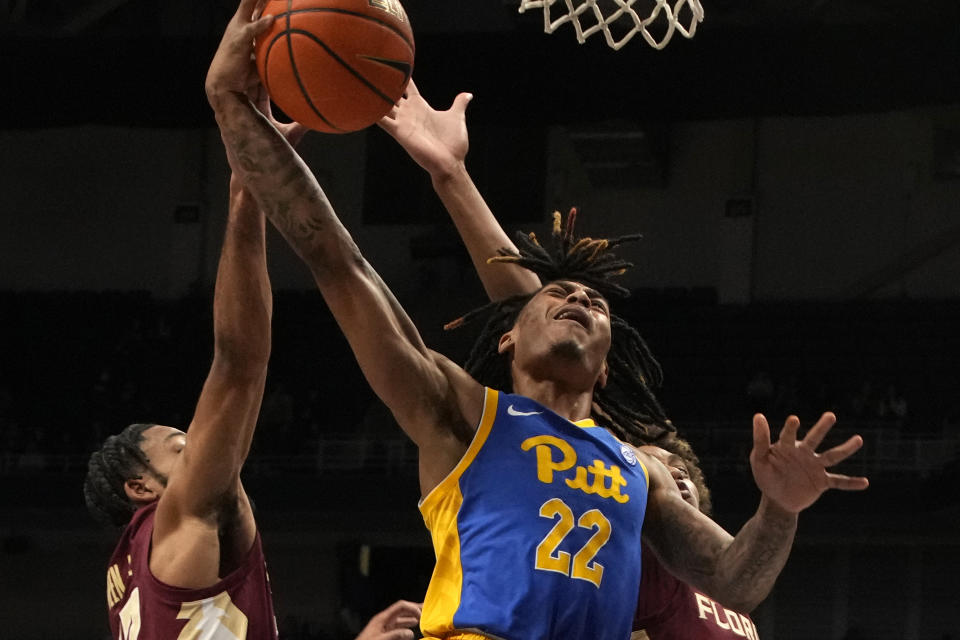 Pittsburgh guard Nike Sibande (22) has a shot blocked by Florida State guard Darin Green Jr., left, during the first half of an NCAA college basketball game in Pittsburgh, Saturday, Jan. 21, 2023. Florida State won 71-64. (AP Photo/Gene J. Puskar)