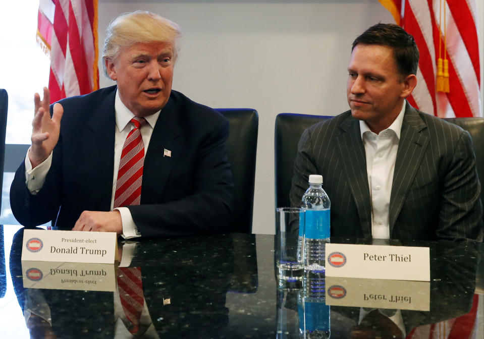 U.S. President-elect Donald Trump sits with PayPal co-founder and Facebook board member Peter Thiel, during a meeting with technology leaders at Trump Tower in New York U.S., December 14, 2016. REUTERS/Shannon Stapleton