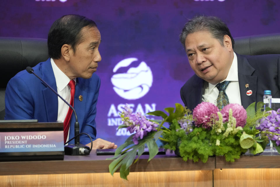 Indonesian President Joko Widodo, left, talk to Coordinating Minister for Economics Airlangga Hartarto during a press conference at the end of the Association of Southeast Asian Nations (ASEAN) Summit in Jakarta, Indonesia, Thursday, Sept. 7, 2023. (AP Photo/Achmad Ibrahim)